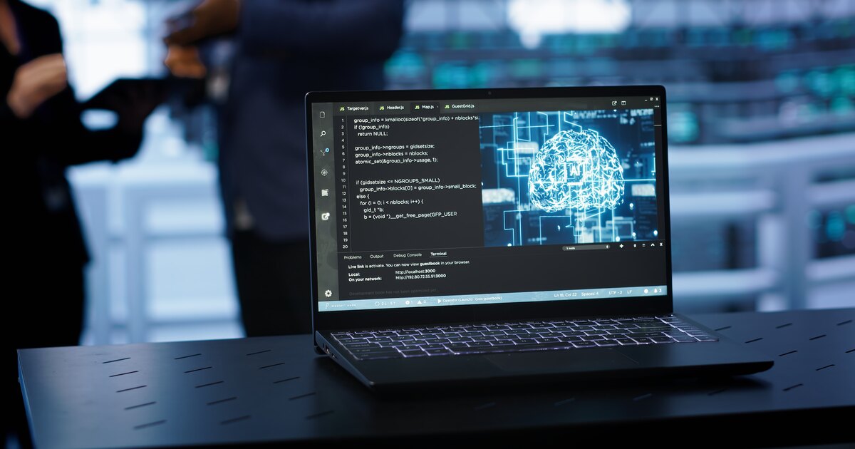 Laptop displaying AI model code next to a glowing neural-network diagram, illustrating how answer engines retrieve and synthesize sources